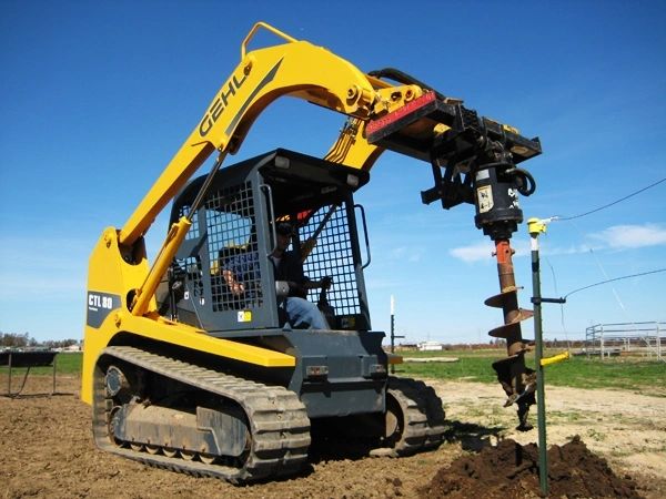 Tracked loader with auger drilling foundation pier